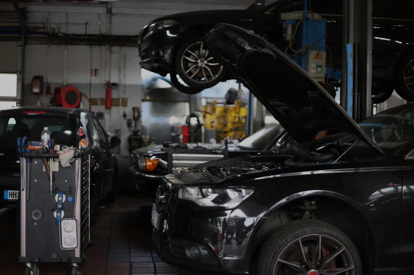 Car with its hood open in a repair shop, illustrating a lemon law Illinois repair claim