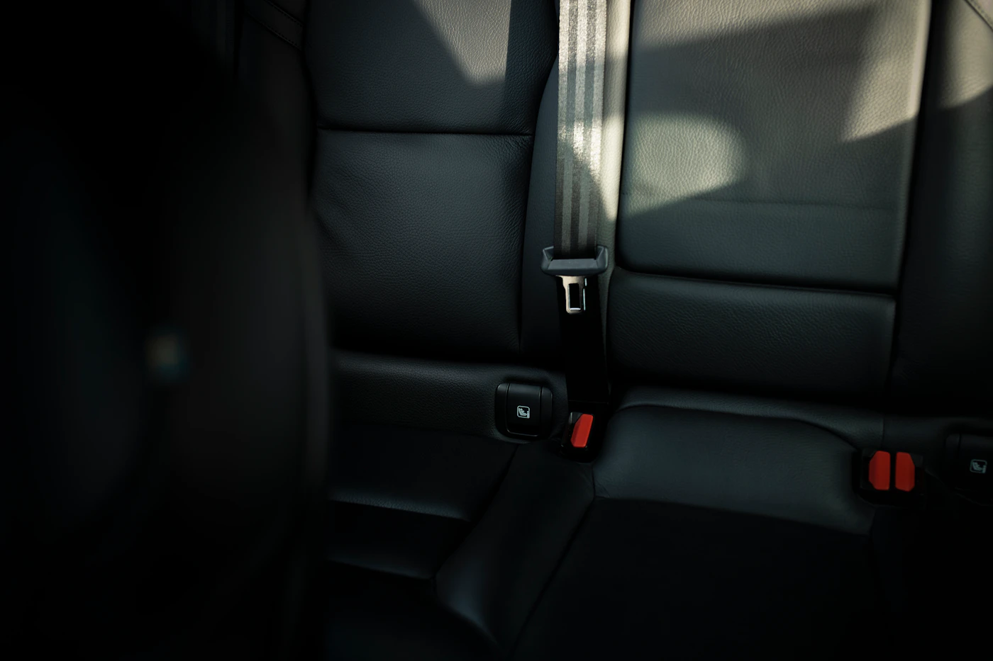Empty back seat of a car where Michigan car seat laws require children to ride